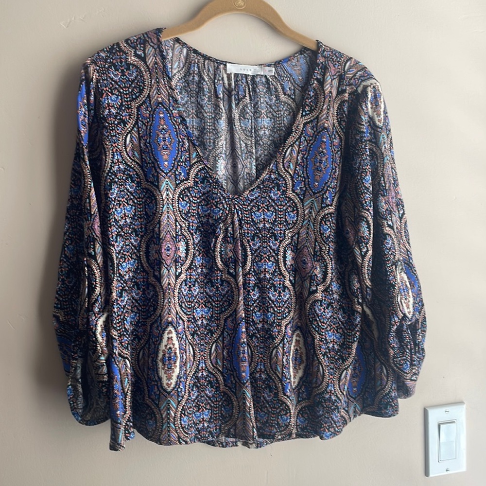 Loose below waist blouse.